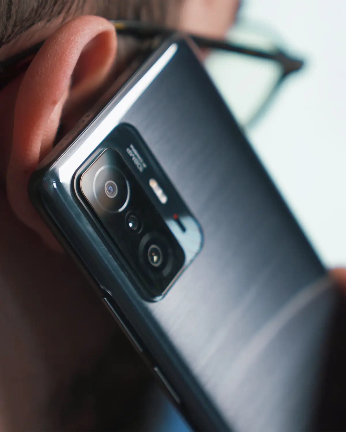 A phone held to a caller's ear