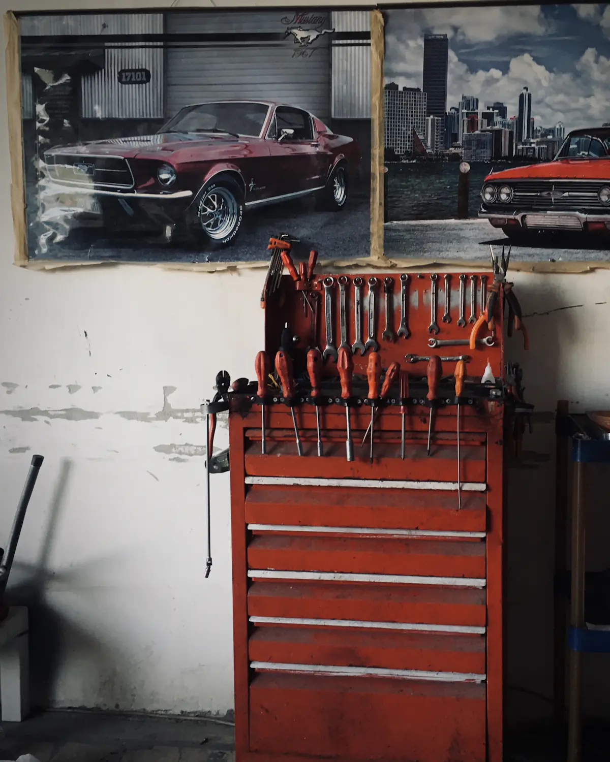 A workshop wall with a red tool chest